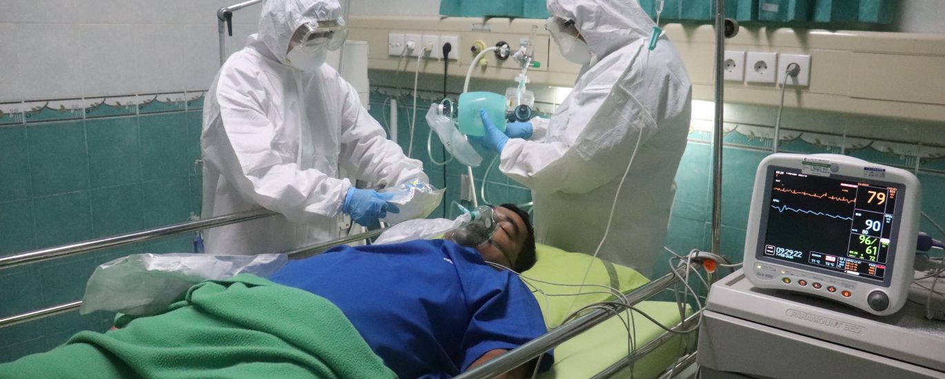 man in white medical scrub lying on hospital bed