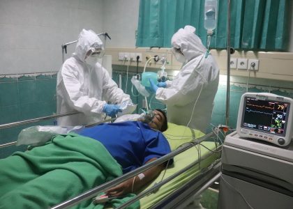 man in white medical scrub lying on hospital bed