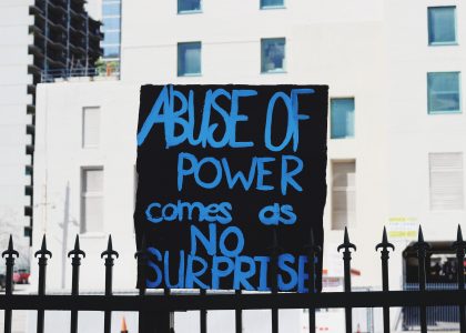 black abuse of power comes as no surprise signage